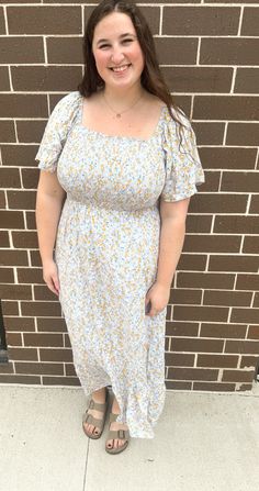 Square neck smocked floral midi dress with flare sleeves and lining.