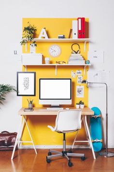 an office with yellow walls and white desks in front of a computer monitor on a wooden