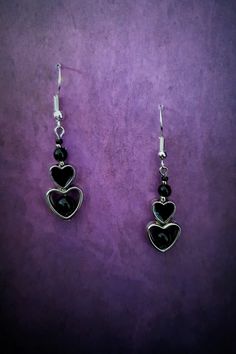 Introducing our stunning Gothic Black Heart Dangle Earrings! These captivating earrings are the perfect accessory for those with a dark and mysterious edge. Crafted with exquisite attention to detail, each earring features a beautifully intricate black heart design, symbolizing passion and intensity. These earrings are lightweight and comfortable to wear, ensuring you can showcase your unique style all day long. Whether you're dressing up for a Gothic-inspired event or simply want to make a statement, these earrings will add a touch of allure and sophistication to any ensemble. Embrace your inner darkness with our Gothic Black Heart Dangle Earrings and let them be a reflection of your unique personality. Each product is one of a kind so there might be slight variations in colour, thickness Nickel-free Black Heart-shaped Jewelry, Nickel-free Black Heart Jewelry, Gothic Black Heart-shaped Earrings, Black Heart-shaped Pierced-style Jewelry, Black Sterling Silver Heart Earrings, Gothic Metal Earrings For Valentine's Day, Black Metal Jewelry For Valentine's Day, Valentine's Day Black Metal Jewelry, Black Heart Earrings As A Gift