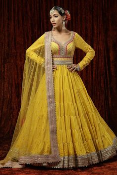 Lemon yellow anarkali rani pink with gota, dori, badla embroidery and tiered detailing. Paired with dupatta and belt.
Component: 3
Pattern: Embroidery
Type Of Work: Gota, dori, badla
Neckline: Leaf
Sleeve Type: Churidar sleeves
Fabric: Anarkali : Silk Chanderi, Raw Silk, Dupatta : Net, Lining: Shantoon, Taffeta
Color: Yellow
Other Details: 
Tassel border
Back cut-out
Embroidered sheer dupatta
Occasion: Sangeet - Aza Fashions Chanderi Lehenga, Haldi Outfits, Haldi Outfit, Wedding Lehenga Designs, Yellow Lehenga, Lehenga Designs Simple, Green Lehenga, Gaun Fashion, Blue Lehenga