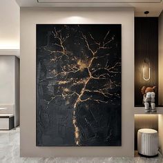 a large black and gold painting hanging on the side of a wall in a living room