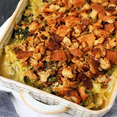 a casserole dish with chicken and broccoli covered in croutons