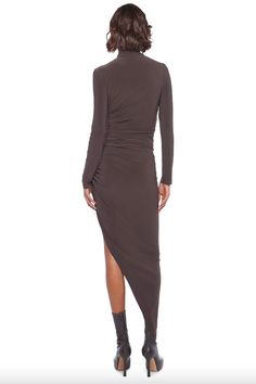 Top off your look with Norma Kamali's long sleeve turtleneck side drape. Crafted from sleek, fitted fabric, this elegant style is perfect for your next cocktail event. Its timeless design ensures a high-fashion look for years to come. 4-WAY STRETCH POLY LYCRA COMPOSITION: 95% POLYESTER 5% SPANDEX