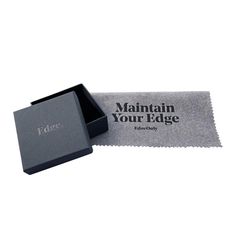 an empty box with the word maintain your edge printed on it, sitting next to a piece of cloth