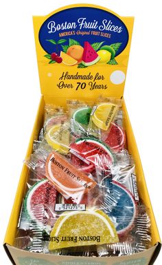 an open box of frozen fruit snacks with lemons and grapefruit on the side