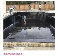 some people are doing construction work on a swimming pool that is being built into the ground