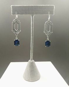 These Deco dangles are the perfect earrings for a 1920s themed wedding or party. Sapphire blue vintage glass beads dangle from silver plated brass Art Deco style connectors. The silver plated brass stampings have an ornate front and a reverse side that is slightly hollow. (SEE 2nd PHOTO) These earrings are lightweight (lobe friendly) yet sturdy, free of lead and nickel. The earrings measure 2 1/4 inches long from the top of the ear wires to the bottom of the glass beads. They hang from silver pl 1920s Themed Wedding, Art Deco Jewelry 1920s, 1920s Wedding Theme, Blue Art Deco, 1920s Wedding, Earrings Art Deco, Pearl Jewels, Edwardian Jewelry, Brass Art