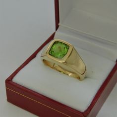 Gemstone: Peridot (from USA) Treatments: Untreated Specifications: 8x8mm, approx. 2.53 carats Color: As shown Clarity: Eye clean Cut: Cushion cut Weight: 16 grams. Ring size: 10, with all sizes available from 6.5 through 12 This is as fine and elegant a man's ring as you will ever find. The perfect blend of a fine gemstone matched up with a clean classic 14K yellow gold ring. Good solid weight, nicely distributed to give the ring an even weight so that it will not spin. There is nothing worse th Classic Gold Ring With Peridot, Green Rectangular Signet Ring For Formal Occasions, Formal Rings With Polished Peridot, Green Prong Set Signet Ring For Formal Occasions, Formal Peridot Rings With Polished Finish, Gold Peridot Rings For Formal Occasions, Anniversary Green 14k Stamped Signet Ring, Green 14k Gold Hallmarked Signet Ring, Classic Peridot Ring For Formal Occasions