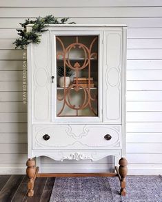 an old china cabinet painted in white and gold