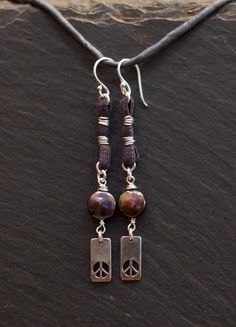 handmade/unique/one of a kind/ one world jewelry/ more than skin deep/ more than us/ pay it forward/ givingthroughjewelry/ empathic warrior/ GIVINGTHROUGHJEWELRY Peace, solitude, serenity. These handcrafted earrings are of sterling silver,  fresh water pearls and earth conscious hand dyed cotton fiber.  The color of purple smoke and incense. Wind chimes on your ears. These measure 2.75 in.,(7cm.) in total length. 10% of this sale will go to buyer's choice of charity. Please leave choice in note Bohemian Sterling Silver Hand-wrapped Earrings, Hippie Sterling Silver Nickel-free Jewelry, Bohemian Sterling Silver Hand Wrapped Earrings, Earthy Dangle Jewelry For Everyday, Hippie Style Sterling Silver Nickel-free Jewelry, Nickel-free Sterling Silver Hippie Jewelry, Earthy Everyday Dangle Jewelry, Silver Hippie Dangle Jewelry, Adjustable Earthy Sterling Silver Jewelry