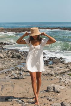 FINAL SALE. Introducing the Willow Chiffon Babydoll Mini Dress. The flowy fabric and tie detailing add a touch of whimsy, while the babydoll silhouette keep it classic. Short Sleeve Beach Dress With Tie Back, Short Sleeve Tie Back Beach Dresses, White Boho Ruffled Dress For Beach, White Ruffled Boho Dress For Beach, Flowy Ruffled Beach Dresses, Flowy Beach Dress With Ruffles, Beachy Flowy Dress With Ruffles, White Bohemian Sundress With Tie Back, Off White Summer Sundress For The Beach