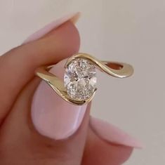 2CT Oval Moissanite Engagement Ring, Yellow Gold 10k/14k/18k Bypass Engagement Ring, Solitaire Diamond Ring for Women, Bezel Set Ring 💍 𝗠𝗲𝘁𝗮𝗹 💍 Color: Yellow Gold, Rose Gold, White Gold (As per Selection) Purity: 9KT, 10KT, 14KT, 18KT (As per Selection) Assurance: All jewelry will come with stamping 💎 𝐌𝐨𝐢𝐬𝐬𝐚𝐧𝐢𝐭𝐞 𝐃𝐞𝐭𝐚𝐢𝐥𝐬 💎 Color Grade: D (Colorless) Clarity Grade: VVS1 Cut Grade: Excellent Polish: Excellent Symmetry: Excellent Fluorescence: Excellent Mohs scale hardness: 9.25 (Natural diamond has 10) Toughness: Excellent Diaphaneity: Transparent Specific gravity: 3.218-3.22 Refractive index: nω = 2.654 nε = 2.967 Birefringence: 0.313 (6H form) Dispersion: 0.104 Melting point: 2730 oC (decomposes) Solubility: None 💎 𝐌𝐚𝐢𝐧 𝐃𝐢𝐚𝐦𝐨𝐧𝐝 𝐃𝐞𝐭𝐚𝐢𝐥𝐬 💎 Shape/C