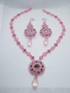 "This stylish set includes matching  pendant and earrings featuring pear shaped dazzling natural pink bicone and preciosa seeds beads, This 16\" long necklace 3\" earrings looks fubolas around your neck,  Wonderful shiny pink crystal bicone and seeds beads, and silver plated flowers stud and lobster claws clasp  Wonderful elegance simple design and the perfect length for showing off a -V- neck and to highlight the face. I hope my hand made necklace set complete with your favourite evening dresse Pink Teardrop Crystal Jewelry, Pink Beaded Crystal Jewelry, Handmade Pink Teardrop Necklaces, Handmade Pink Teardrop Necklace, Handmade Pink Crystal Jewelry, Teardrop Crystal Jewelry With Dangling Beads, Teardrop Shaped Crystal Jewelry With Dangling Beads, Pink Elegant Dangle Beaded Necklaces, Pink Crystal Beaded Necklaces