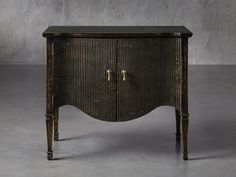 an old wooden cabinet sitting on top of a cement floor