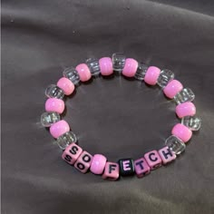 a pink and clear beaded bracelet with the word boofetch written on it