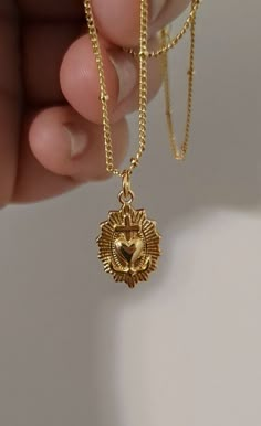 Discover elegance and spiritual grace with our 24k Gold-filled Dainty Sacred Heart Necklace. Delicately crafted and measuring 18 inches in length, this necklace features a beautifully detailed Sacred Heart pendant that symbolizes love, devotion, and protection. The intricate design and high-quality materials make it a perfect piece for everyday wear or special occasions, adding a touch of timeless beauty to any outfit. Treat yourself or a loved one to this exquisite blend of faith and fashion, m