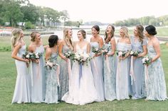 a group of women standing next to each other on top of a lush green field