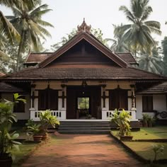 a white and brown house surrounded by palm trees