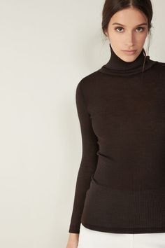 Long-sleeve high-neck tubular top made from a wool-silk blend. Chic High Neck Fine Knit Turtleneck, Chic Fine Knit High Neck Turtleneck, Wool Turtleneck Top For Layering, Merino Wool Turtleneck Top For Work, Stretch Wool Tops For Fall, Wool High Neck Fine Knit Top, Wool Funnel Neck Tops For Fall, Fall Wool Top With Funnel Neck, Brown High Neck Top For Work