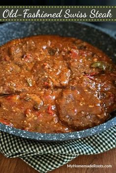 an old fashioned swiss steak stew in a cast iron skillet