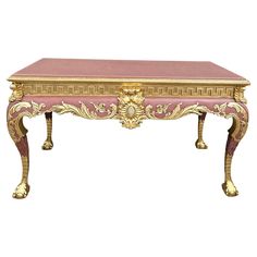 an antique pink and gold coffee table