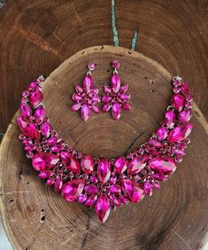 "Statement necklace and earrings set These fun and stylish pink teardrop cluster crystal rhinestone necklace and earrings set are a great statement piece!  Size of earrings: 2\" Long.  Necklace 17\"long with 3\" chain extender Decor Size: 2.5\" Color: hot pink/fuchsia rhinestones  Base metal color: silver More colors available upon request, just message us! Need a matching bracelet? https://www.etsy.com/listing/607744629/fuchsia-bracelet-hot-pink-bracelet?ref=shop_home_active_59 https://etsy.me/2UTFrJ4  https://etsy.me/2VJu5W8  https://etsy.me/3hBB6Uo  Looking for the perfect pair of earrings for a special occasion. We specialize in custom work in fashion jewelry, pearls, and natural stones! Please feel free to browse through our other listings, and if you can't find what you are looking f Pink Teardrop Crystal Jewelry, Pink Crystal Glamorous Necklace, Glamorous Pink Crystal Necklace, Pink Crystal Jewelry Sets With Rhinestones, Pink Crystal Rhinestone Necklace, Pink Crystal Rhinestone Necklace In Glamorous Style, Pink Rhinestone Jewelry Set For Party, Glamorous Pink Rhinestone Necklace For Party, Teardrop Pink Rhinestone Jewelry