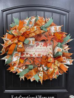 an orange and green fall wreath on the front door with words that read fall is coming