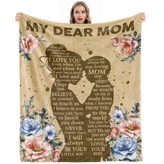 a woman holding up a blanket with the words,'my dear mom'on it