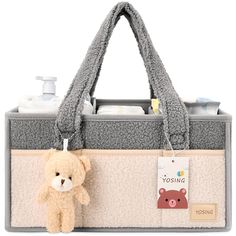 a teddy bear hanging from the side of a bag