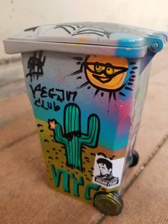 a trash can with some graffiti on it