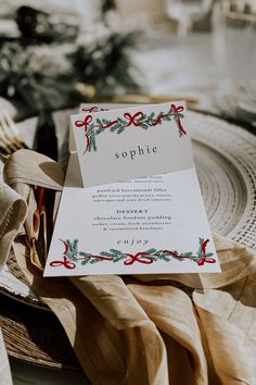 a table setting with napkins, plates and place cards on top of each other