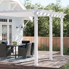 an outdoor dining area with white pergolan and black wicker chairs on a wooden deck