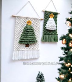 two wall hangings decorated with green and white christmas trees, one is made out of yarn