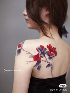 the back of a woman's shoulder with flowers painted on her upper arm and chest