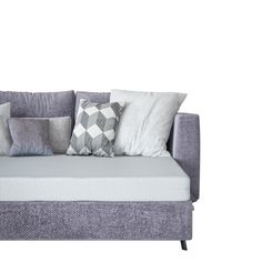 a gray couch with pillows on it and a white wall in the backround