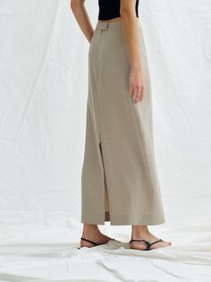 Editor's NotesThis is a chic mood maxi skirt. It is an attractive item with a vintage color feeling made of washed tencel material in a minimalistic design.- Creates a feminine silhouette with high waist and H-line.- It is natural and stylish with a falling texture.- Skirts with side pockets, covered button on the back and zipper closure- There is a back opening to add activity*The color of the image may differ from the actual color depending on the resolution of your monitor.Measurements (inch) Solid Color Midi Length Bottoms For Summer, Summer Workwear Maxi Skirt, Summer Full Length Maxi Skirt For Workwear, Summer Workwear Full-length Maxi Skirt, Daywear Long Rayon Skirt, Beige Midi Length Bottoms For Daywear, Spring High Waist Maxi Skirt With Side Slits, Spring Relaxed Full Length Maxi Skirt, Spring Full Length Relaxed Maxi Skirt