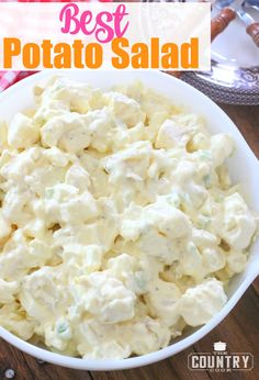 a bowl filled with potato salad on top of a wooden table