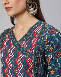 This chic set features a blue ethnic motif print angrakha shape anarkali kurta paired with matching trousers and dupatta offering a blend of elegance and contemporary style. The kurta boasts intricate floral print work that add charm and sophistication, while the trousers complement the ensemble with their coordinated design and printed dupatta. Perfect for both casual outings and special occasions, this set exudes effortless flair and cultural elegance in every detail. No of Sets - 3 Color - Blue Work Done - Ethnic Motif Print Detailing Kurta Fabric - Cotton Kurta Detailing - Angrakha Anarkali shape kurta, round neck with 3/4th Sleeves Trouser Fabric - Cotton Elasticated Waistband Slip on Closure Dupatta Fabric - Cotton Care - Machine Wash Model - 5"8 wearing size small Disclaimer : Sligh Blue Anarkali Set With Motifs, Blue Ikat Print Kurta For Festivals, Blue Ikat Print Kurta For Festive Occasions, Blue Salwar Kameez With Printed Border For Diwali, Traditional Blue Anarkali Set With Printed Border, Navratri Anarkali Set With Printed Border, Straight Kurta, Diwali Blue Salwar Kameez With Printed Border, Blue V-neck Kurta With Printed Motifs, Festive Blue Ikat Print Kurta