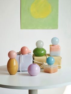 a table topped with lots of different colored vases