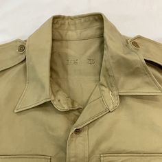 Vintage military button up top 1940s size: L chest-25” shoulder-7” sleeve-24” top to bottom-31” Military Style Button-up Tops With Snap Buttons, Military Button-up Shirt, Military Style Button-up Tops, Classic Khaki Tops With Buttons, Collared Khaki Top With Snap Buttons, Khaki Collared Top With Snap Buttons, Military Style Collared Top With Button Closure, Military Style Collared Top With Snap Buttons, Military Style Collared Shirt With Snap Buttons