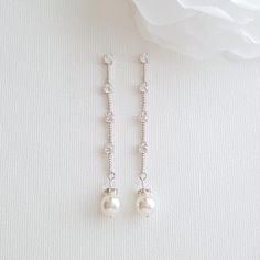 Delicate and dainty, the Ginger earrings are long created in a simple style with tiny 4mm cubic zirconia round crystals interspersed with shiny etched metal. I have added a Swarovski round pearl drop to them. They are lightweight drop earrings and comfortable for long wear. They will swing and dance when worn, the little crystals catch the light for the sparkle and yet are understated and great for some one looking for minimalist earrings. Earrings are made with cubic zirconia and all material u Delicate Silver Pearl Earrings With Cubic Zirconia, Silver Dainty Pearl Earrings With Cubic Zirconia, Round Cubic Zirconia Linear Earrings For Wedding, Silver Cubic Zirconia Dainty Pearl Earrings, Dainty Silver Pearl Earrings With Cubic Zirconia, Minimalist Cubic Zirconia Wedding Earrings, Wedding Linear Cubic Zirconia Earrings, Long Drop Linear Earrings With Diamond Accents For Wedding, Delicate Dangle Cubic Zirconia Pearl Earrings