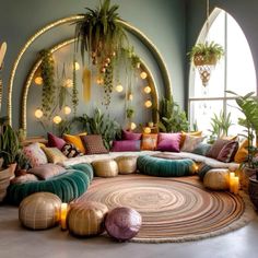 a living room filled with lots of plants and pillows on top of a round rug