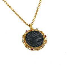 This stunning gold coin necklace stands out with its truly unique design that makes it special. Inspired by ancient coin jewelry, the necklace features a harmonious balance of 3 ruby stones and 3 white zircon stones. The materials used in this piece, brass plated with 24-carat pure gold, reflect the elegance of medieval necklace styles. With aesthetics drawn from Hellenistic jewelry, this necklace brings a touch of ancient history into modern fashion. The gold coin pendant captures the essence of traditional coin jewelry designs, resembling Greek coin jewelry. The gold disc pendant design makes this piece both timeless and sophisticated. The chain length is 20.47 inches, while the pendant measures 2.36 inches in height and 1.77 inches in width. Offering the perfect blend of historical sign Elegant Handmade Coin Necklace, Handmade Elegant Coin Necklace, Elegant Coin Shaped Locket Necklace, Elegant Coin-shaped Locket Necklace, Hellenistic Jewelry, Medieval Necklace, Gold Coin Pendant, Ancient Coin Jewelry, Necklace Styles