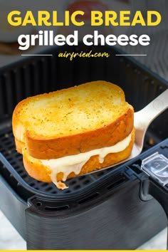 a grilled cheese sandwich is being held by a spatula with the words garlic bread grilled cheese on it