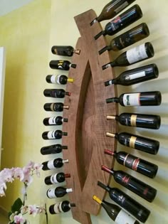 a wooden wine rack with many bottles on it