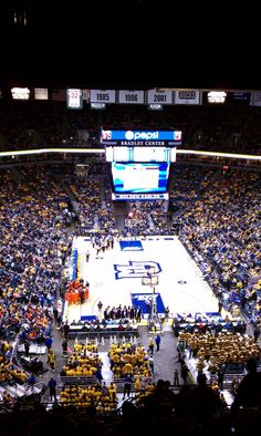 an indoor basketball court with fans in the stands