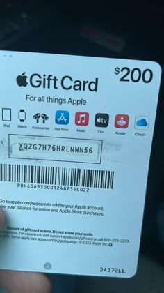 someone is holding up a $ 200 apple gift card in their left hand, with the bar code for all things apple