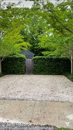 an outdoor area with gravel and trees