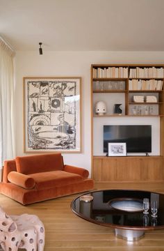 a living room filled with furniture and bookshelves