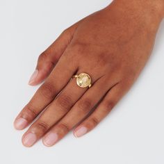 a woman's hand with a gold ring on it